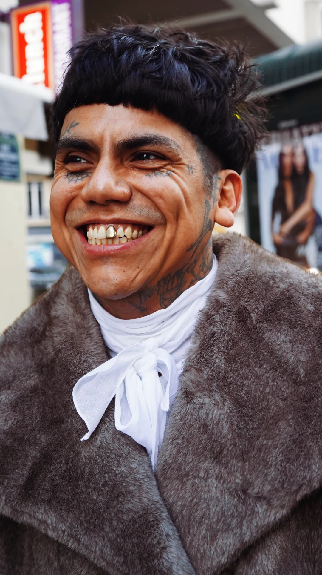 Street portrait of a smiling man in a fur coat and white cravat