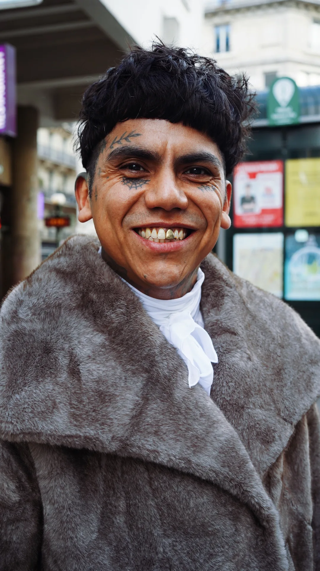 Portrait of a smiling man in a fur coat with a white cravat on a city street